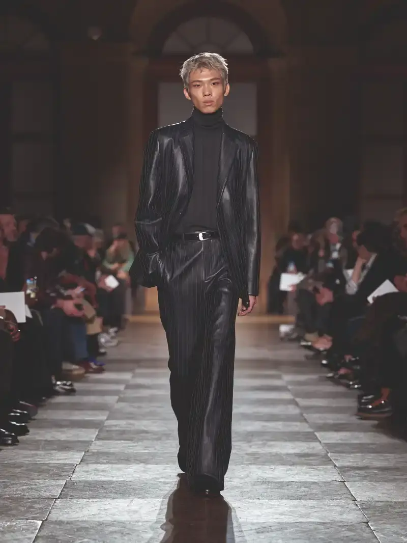 HERMÈS MENSWEAR FW26 COLLECTION Article about Hermès Fall Winter 2026 menswear collection designed by Véronique Nichanian. The collection emphasizes clean construction, quality fabrics, and interior garment finishing. Color palette ranges from hemp and lichen to saffron and midnight blue. The design philosophy focuses on timeless pieces and precise craftsmanship. (image 45 of 58)