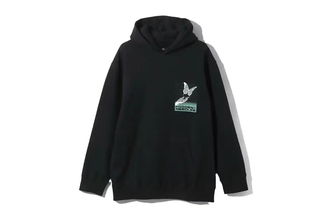 HIDDEN.NY AND NEEDLES UNVEIL LATEST COLLAB CAPSULE HIDDEN.NY and NEEDLES streetwear collaboration capsule collection featuring green hues, overlapping logos, and digital-inspired graphics on classic NEEDLES styles like Cut t-shirts, tracksuits, and mohair cardigans. Exclusive launch at NEPENTHES Tokyo on September 27, including unique REBUILD BY NEEDLES pieces (image 8 of 15)