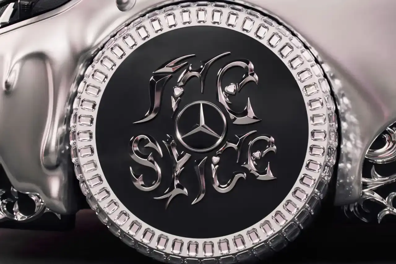 CLA GETS ROYAL CHROME TREATMENT IN ICE SPICE'S MERCEDES COLLAB image of rapper Ice Spice's custom collaboration with Mercedes-Benz, featuring a chrome-finished CLA model with princess-themed detailing. It explains that this is part of Mercedes' "Class of Creators" initiative, where five artists will create custom interpretations of the CLA. The piece details the unveiling event at Mercedes' New York dealership, which included performances from Broadway's "Hell's Kitchen" cast and music by DJ LPX. The article also mentions Ice Spice's upcoming merchandise collection and notes that other collaborators will include Gustaf Westman, KidSuper, League of Legends, and Hot Wheels. (image 6 of 11)