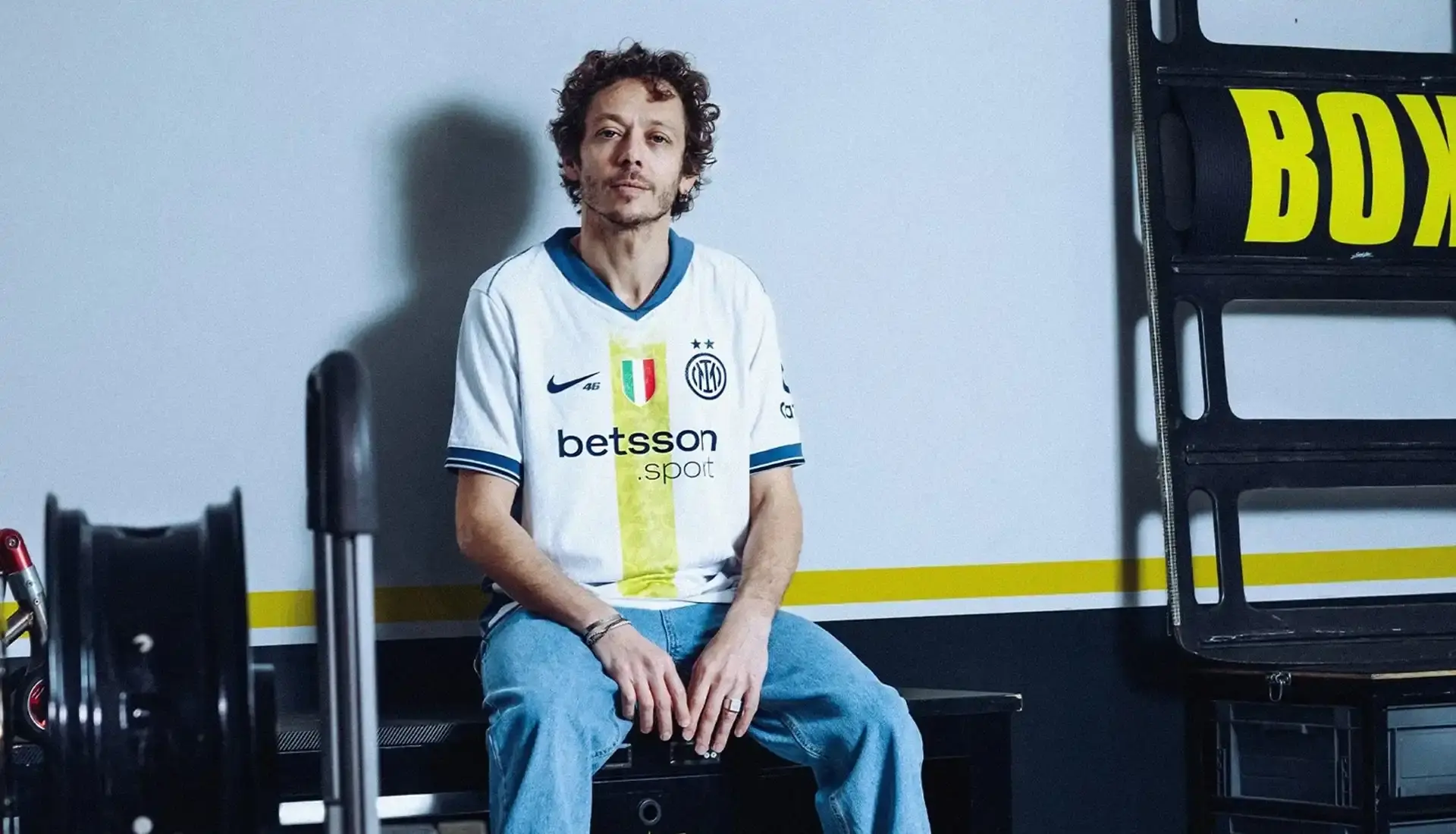 VALENTINO ROSSI INSPIRES INTER'S SPECIAL NIKE AWAY SHIRT photo of special edition Inter Milan away kit created in collaboration with MotoGP champion Valentino Rossi and Nike. The jersey incorporates Rossi's famous Sun and Moon symbols and his racing number 46. The kit will debut during Inter's match against Cagliari on April 12, 2025. The article includes quotes from Rossi expressing his excitement about the collaboration between his two passions: motorcycle racing and football. Information on how to purchase the limited edition shirt is provided at the end. (image 6 of 9)
