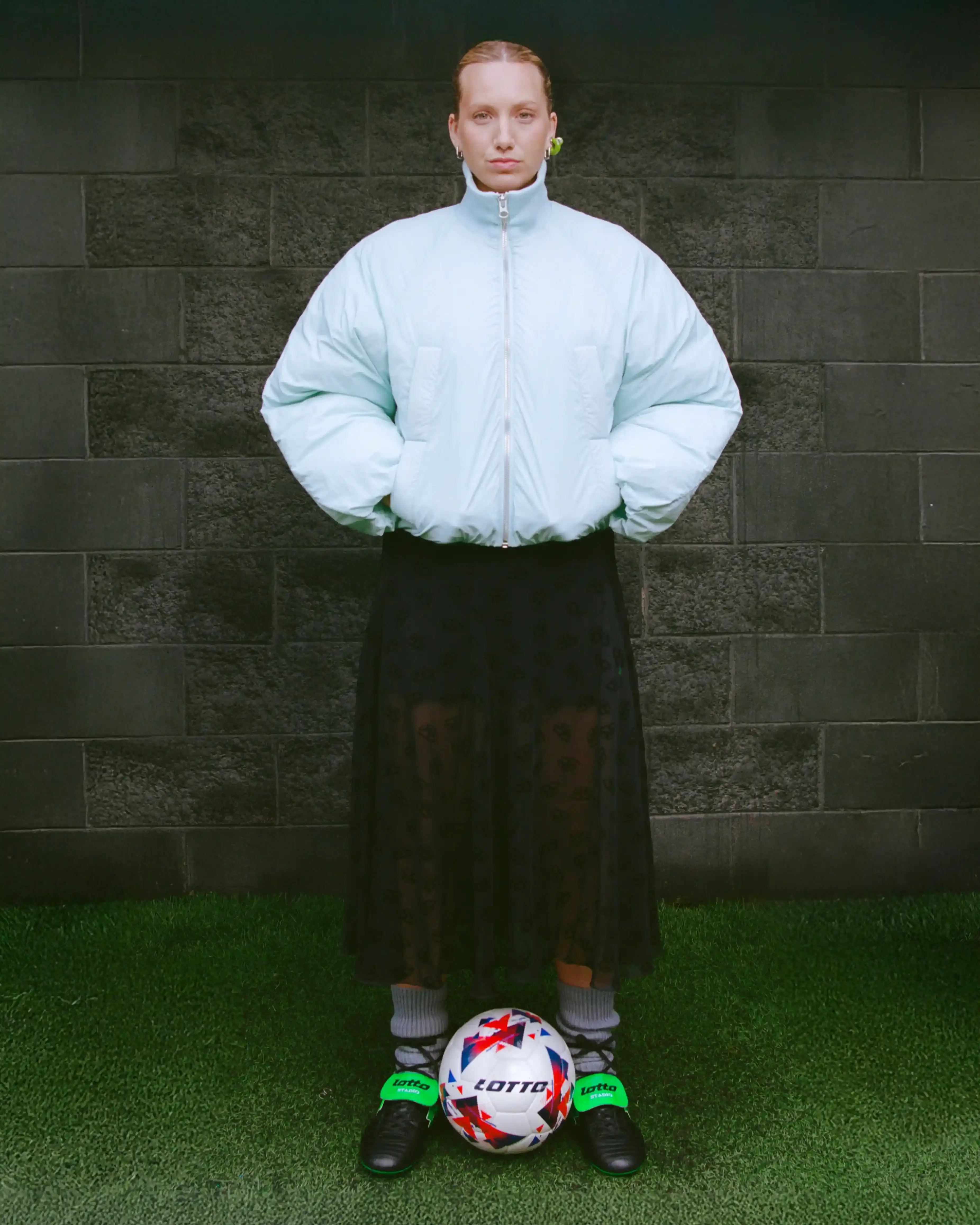 JACKET: MINIMUM / SKIRT: MACCAPANI / SHORTS, SHOES & FOOTBALL: LOTTO SPORT ITALIA / SOCKS: STYLIST’S OWN / EARRINGS: ARIANNA FABIANO JEWELRY JACKET: MINIMUM / SKIRT: MACCAPANI / SHORTS, SHOES & FOOTBALL: LOTTO SPORT ITALIA / SOCKS: STYLIST’S OWN / EARRINGS: ARIANNA FABIANO JEWELRY (image 5 of 7)