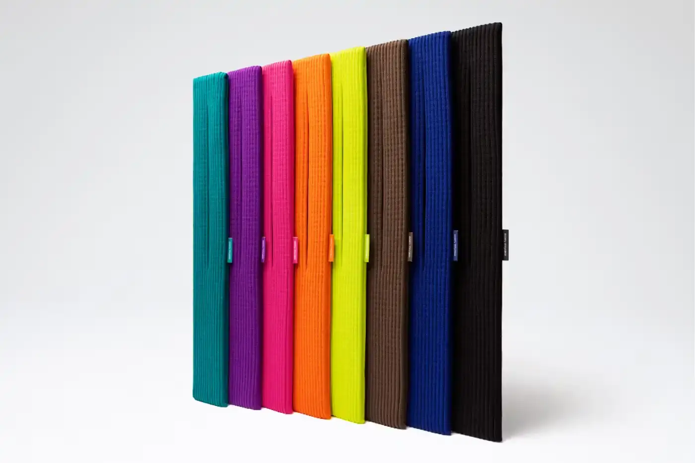 ISSEY MIYAKE AND APPLE LAUNCH IPHONE POCKET A 3D-knitted textile iPhone holder in a rectangular shape with ribbed pleated structure, available with short wrist strap or long crossbody strap in multiple colors, designed by Issey Miyake and Apple. (image 12 of 12)