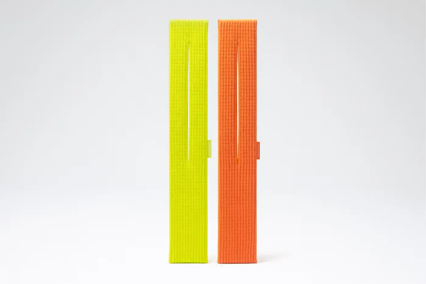 ISSEY MIYAKE AND APPLE LAUNCH IPHONE POCKET A 3D-knitted textile iPhone holder in a rectangular shape with ribbed pleated structure, available with short wrist strap or long crossbody strap in multiple colors, designed by Issey Miyake and Apple. (image 11 of 12)