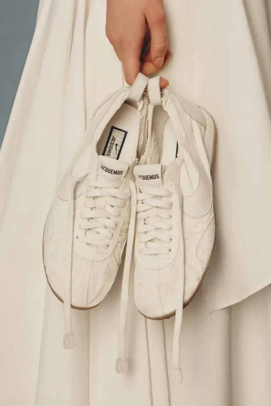 JACQUEMUS AND NIKE DROP NEW MOON SHOES FOR 2026 A text article detailing the Spring 2026 release of three new Jacquemus and Nike Moon Shoe colorways including pricing and design specifications. (image 8 of 8)