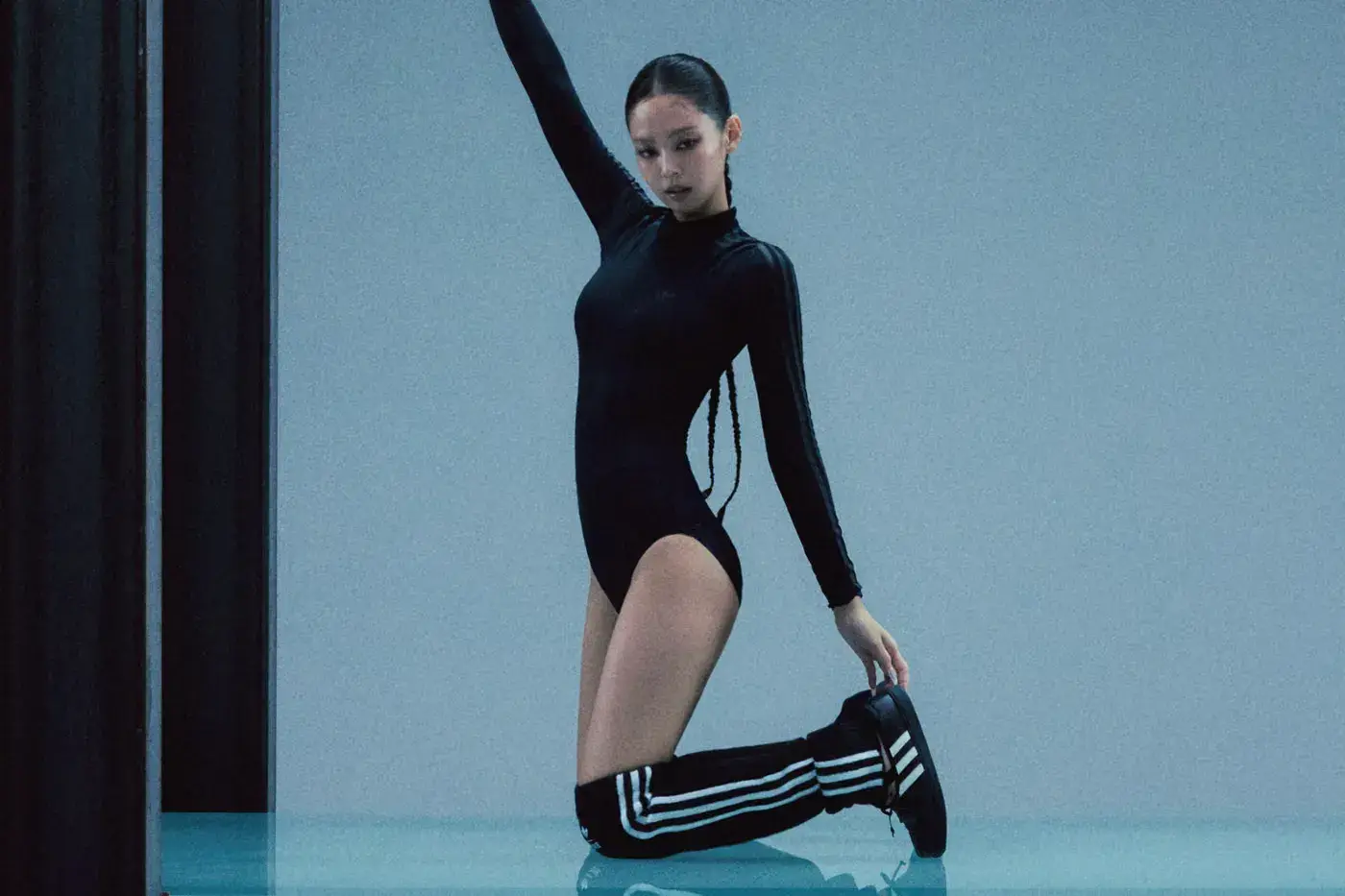 JENNIE AND ADIDAS ORIGINALS LAUNCH FUNCTIONAL GRACE image of Jennie wearing squared-toe sneakers, wrap skirts, and sheer bodysuits from her Adidas Originals capsule line.