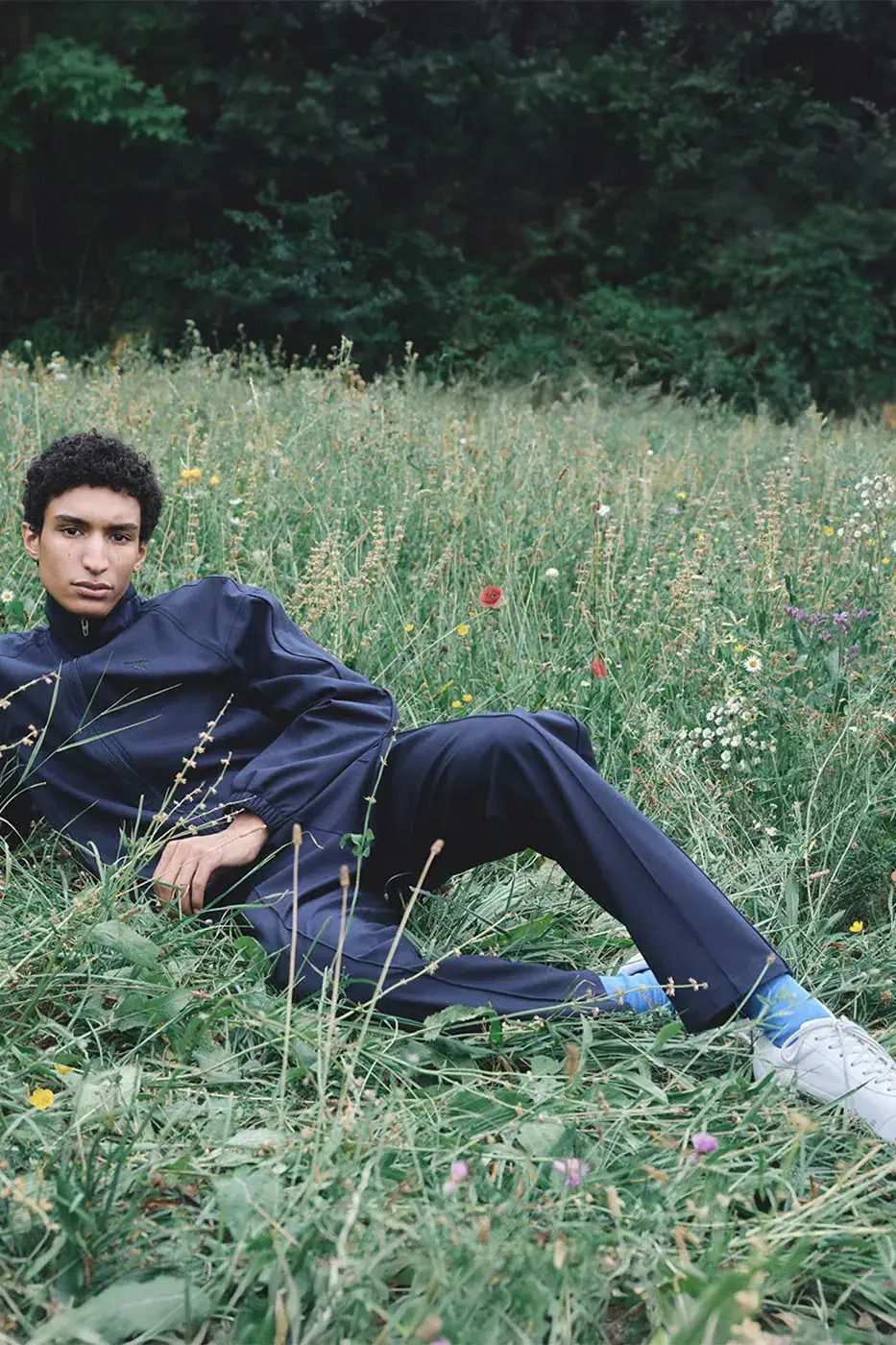 JIL SANDER X PUMA FW26 ADDS APPAREL AND TWO SNEAKERS image about the Jil Sander x PUMA Fall/Winter 2026 collection, covering the wool T7 tracksuit, the Speedcat and Suede sneakers, the campaign and the October 23 launch. A short summary list opens the text.