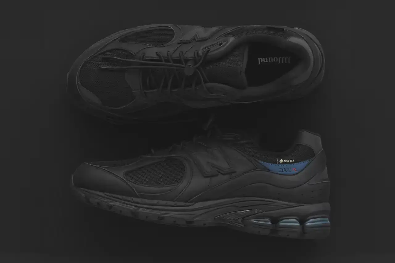 JJJJound JJJJound x New Balance 2002R GORE-TEX sneaker in all-black colorway, featuring mesh and leather construction with a subtle blue heel accent and GORE-TEX waterproof technology (image 2 of 4)