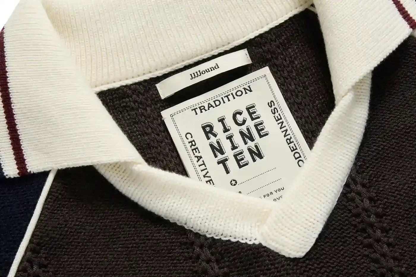 MONTRÉAL'S JJJJOUND TEAMS UP WITH RICE NINE TEN ON KNIT SOCCER JERSEY image of the collaboration between JJJJound and RICE NINE TEN featuring a limited-edition knitted soccer jersey. The piece details the jersey's design elements including textured tuck pattern, contrasting trim, hand-embroidered emblems, and color scheme. Information includes the release date of May 22 at 12 p.m. EST exclusively through JJJJound's website. This is noted as the first partnership between the Montréal design studio and the Japanese brand led by designer Shohei Kimura. (image 2 of 5)
