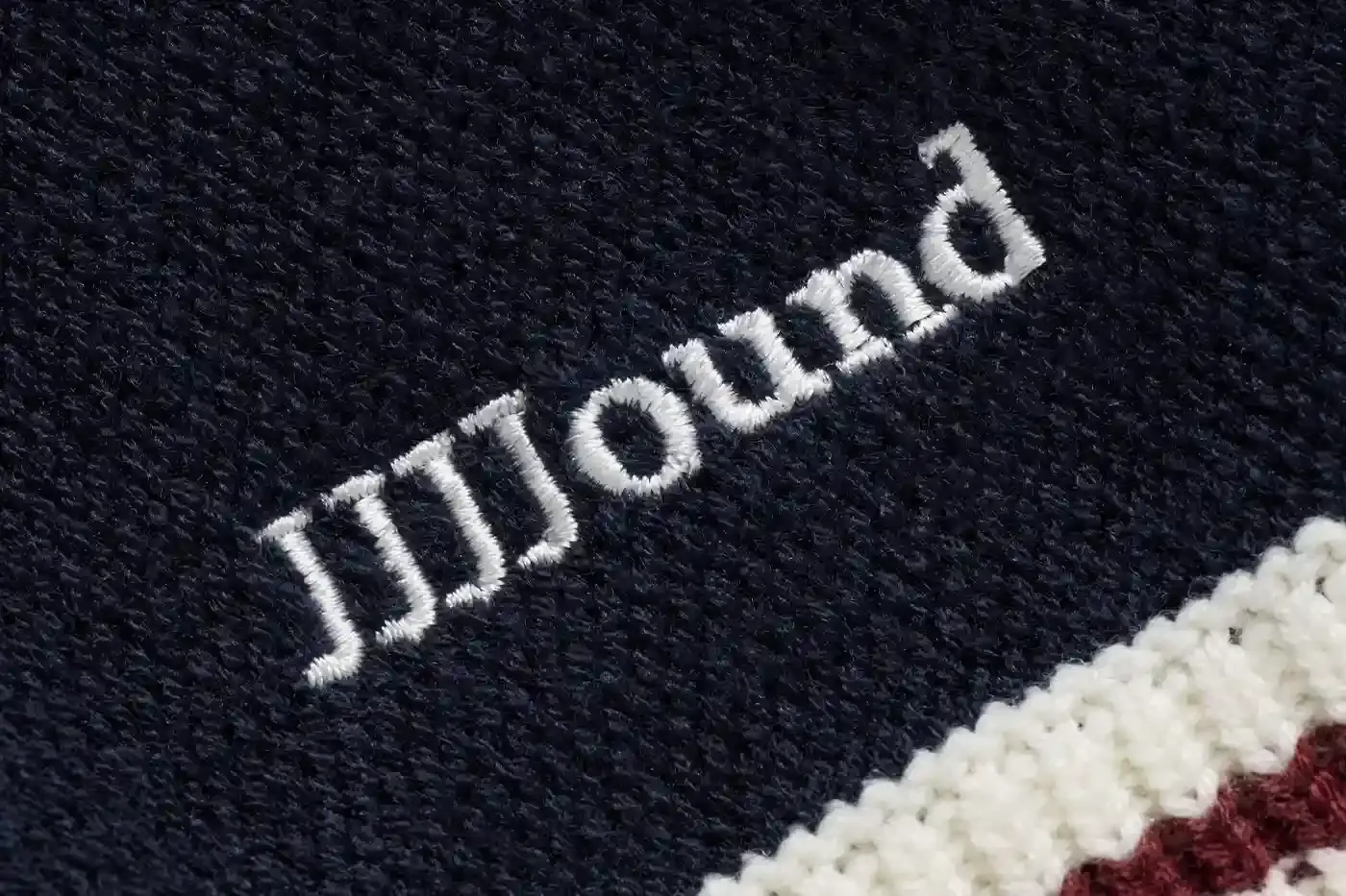 MONTRÉAL'S JJJJOUND TEAMS UP WITH RICE NINE TEN ON KNIT SOCCER JERSEY image of the collaboration between JJJJound and RICE NINE TEN featuring a limited-edition knitted soccer jersey. The piece details the jersey's design elements including textured tuck pattern, contrasting trim, hand-embroidered emblems, and color scheme. Information includes the release date of May 22 at 12 p.m. EST exclusively through JJJJound's website. This is noted as the first partnership between the Montréal design studio and the Japanese brand led by designer Shohei Kimura. (image 4 of 5)