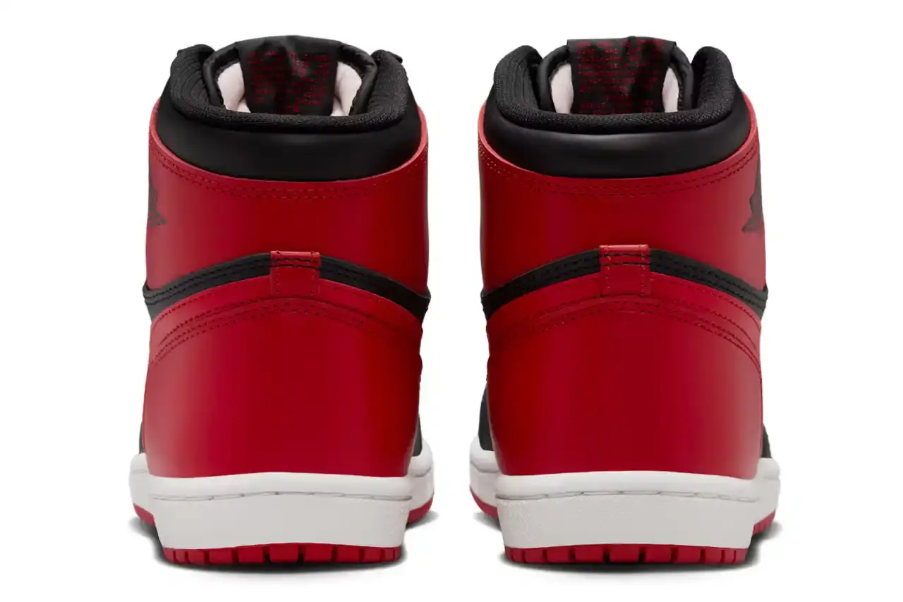 Nike Air Jordan 1 Hi '85 'Bred' sneaker in black and red leather with white midsole. Features original 1985 specifications including modified Swoosh shape, compact Wings logo, and elevated collar height. The shoe has a black leather base with red leather overlays, white Nike Swoosh, and red rubber outsole. (image 5 of 7)