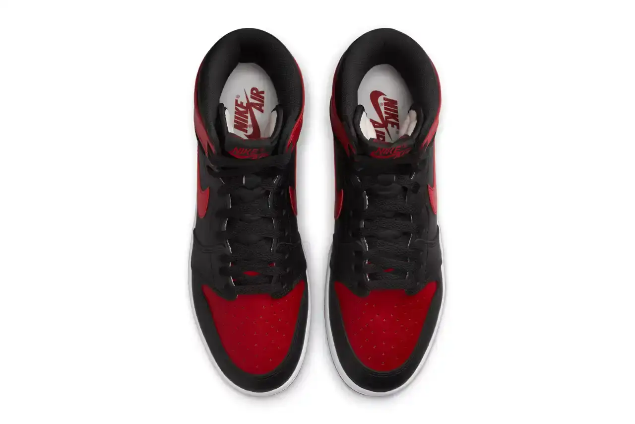 Nike Air Jordan 1 Hi '85 'Bred' sneaker in black and red leather with white midsole. Features original 1985 specifications including modified Swoosh shape, compact Wings logo, and elevated collar height. The shoe has a black leather base with red leather overlays, white Nike Swoosh, and red rubber outsole. (image 4 of 7)