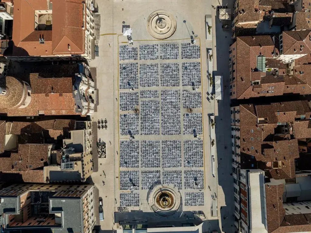 JR INSIDE OUT PROJECT LAUNCHES IN L'AQUILA, ITALY An article outlining a large-scale outdoor photography installation in an Italian public square by JR in L'Aquilia, Italy, photography by Andrea Mancini
