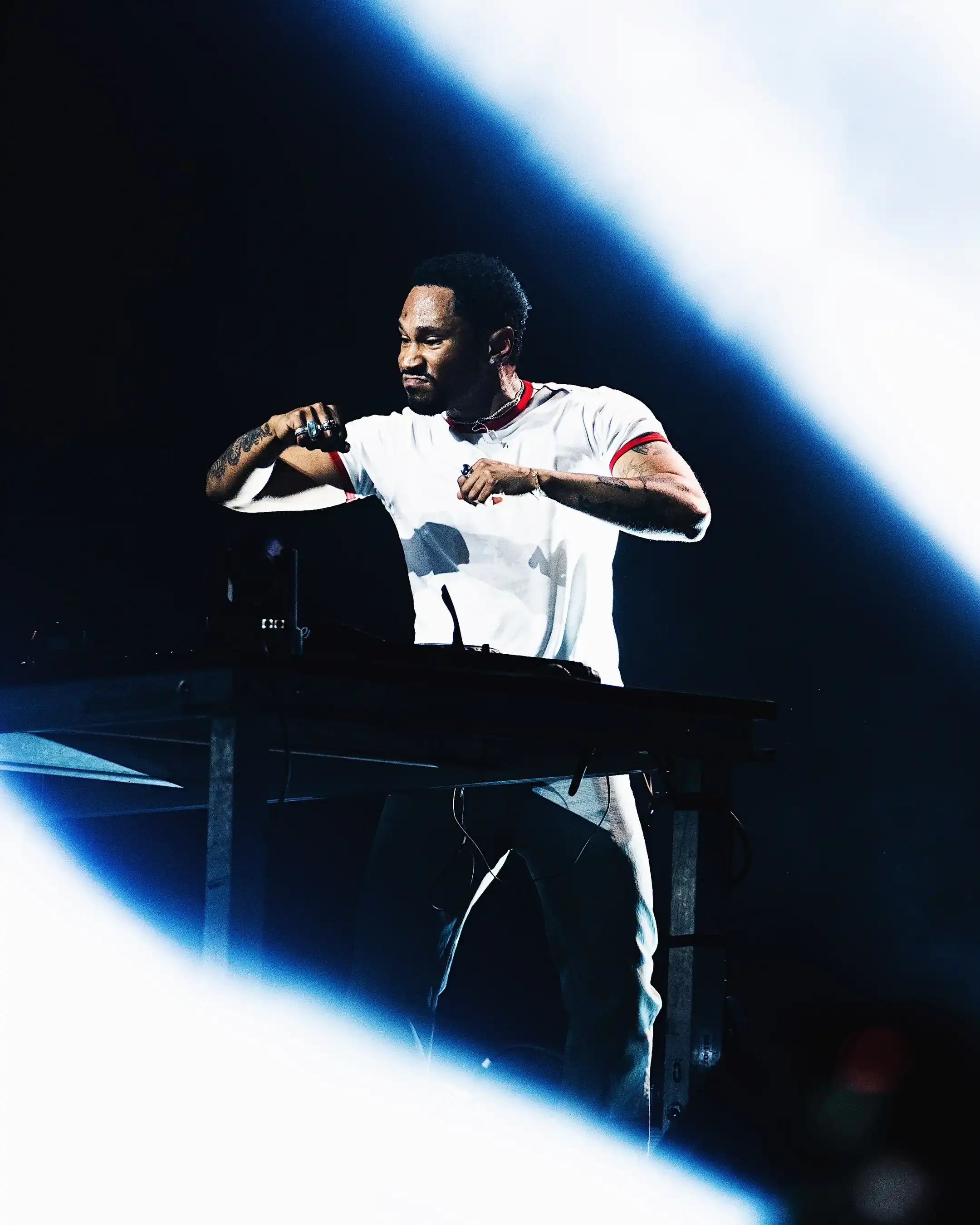 KAYTRANADA: THE ECLECTIC GENIUS Photo of Haitian-Canadian producer Kaytranada, chronicling his rise from SoundCloud remixes to Grammy-winning artist. It details his musical style, major career milestones including his debut album "99.9%" and follow-up "BUBBA," his iconic Boiler Room performance, and his impact on electronic music culture. The article concludes with mentions of his current European tour and recent Milan performance. Content is structured chronologically with clear paragraphs describing his career development, musical innovations, and cultural significance. (image 6 of 7)