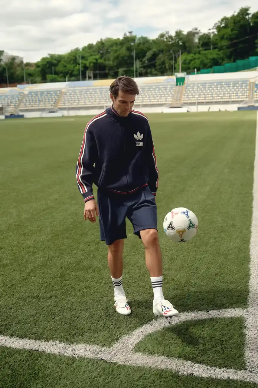 KITH AND ADIDAS FOOTBALL REUNITE AFTER SEVEN-YEAR HIATUS This article announces the Spring 2025 collaboration between Kith and adidas Football after a seven-year hiatus. The collection includes premium apparel (stadium coats, tracksuits, jerseys), footwear (custom Predator models and lifestyle options), and accessories (scarves, bags, headwear). Special collaborations with ESPN, Chase, and DHL Express are highlighted. The full collection launches April 18 online and in Kith retail locations. The article is structured in six paragraphs that outline the collaboration's scope, key apparel pieces, special partnerships, footwear offerings, accessories, and release details. (image 7 of 20)