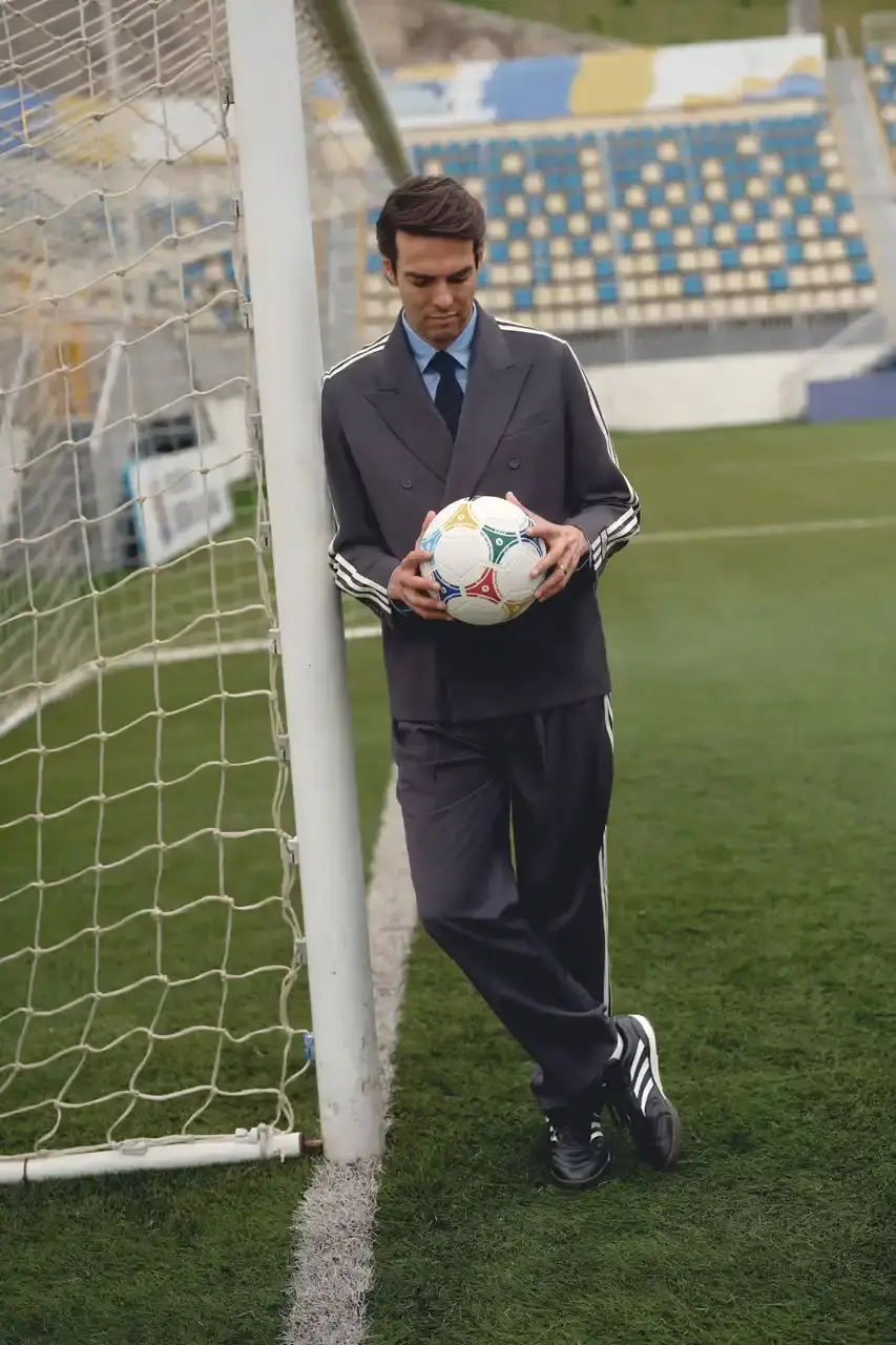 KITH AND ADIDAS FOOTBALL REUNITE AFTER SEVEN-YEAR HIATUS This article announces the Spring 2025 collaboration between Kith and adidas Football after a seven-year hiatus. The collection includes premium apparel (stadium coats, tracksuits, jerseys), footwear (custom Predator models and lifestyle options), and accessories (scarves, bags, headwear). Special collaborations with ESPN, Chase, and DHL Express are highlighted. The full collection launches April 18 online and in Kith retail locations. The article is structured in six paragraphs that outline the collaboration's scope, key apparel pieces, special partnerships, footwear offerings, accessories, and release details. (image 14 of 20)