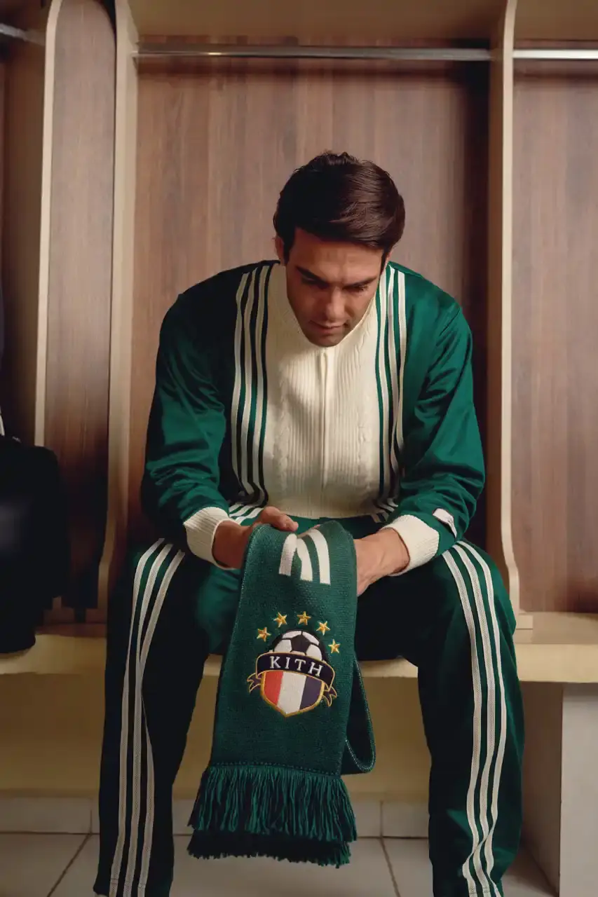KITH AND ADIDAS FOOTBALL REUNITE AFTER SEVEN-YEAR HIATUS This article announces the Spring 2025 collaboration between Kith and adidas Football after a seven-year hiatus. The collection includes premium apparel (stadium coats, tracksuits, jerseys), footwear (custom Predator models and lifestyle options), and accessories (scarves, bags, headwear). Special collaborations with ESPN, Chase, and DHL Express are highlighted. The full collection launches April 18 online and in Kith retail locations. The article is structured in six paragraphs that outline the collaboration's scope, key apparel pieces, special partnerships, footwear offerings, accessories, and release details. (image 16 of 20)