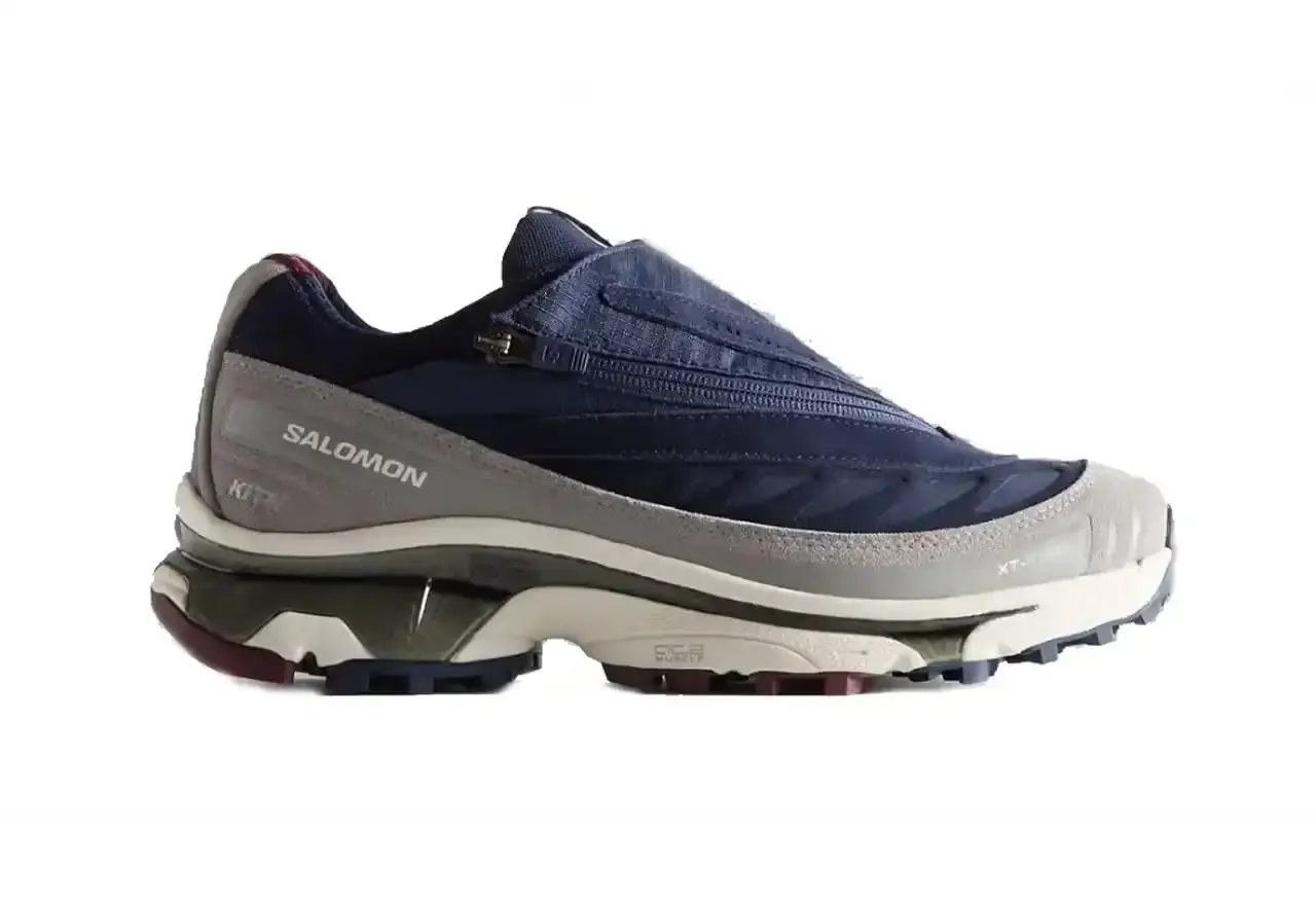 Kith Kith x Salomon XT-Voyager sneaker shown from side angle, featuring blue, grey, white and red colorway with distinctive zipper closure system. (image 9 of 12)