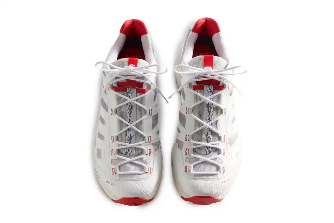 Kith Kith x Salomon XT-Voyager sneaker shown from side angle, featuring blue, grey, white and red colorway with distinctive zipper closure system. (image 2 of 12)