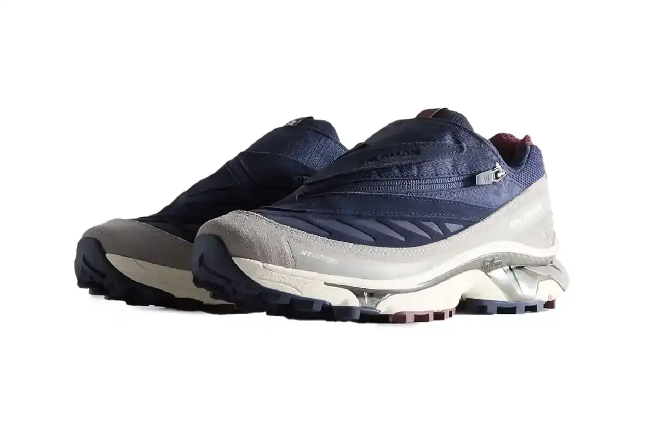 Kith Kith x Salomon XT-Voyager sneaker shown from side angle, featuring blue, grey, white and red colorway with distinctive zipper closure system. (image 11 of 12)