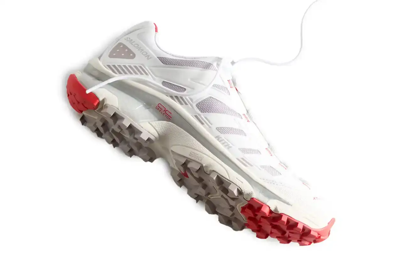 Kith Kith x Salomon XT-Voyager sneaker shown from side angle, featuring blue, grey, white and red colorway with distinctive zipper closure system. (image 3 of 12)