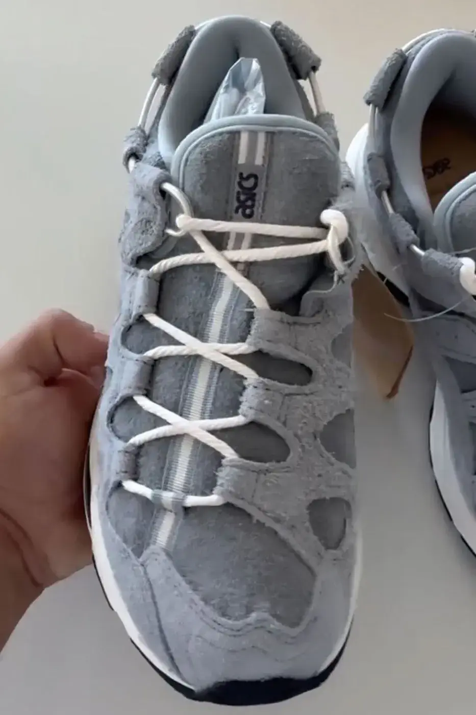 KITH, GIORGIO ARMANI AND ASICS REVEAL THE GEL-MAI 0.1 image about the KITH, Giorgio Armani and ASICS GEL-Mai 0.1, a grey shaggy suede sneaker with navy GEL units and no confirmed release date or price. (image 2 of 5)