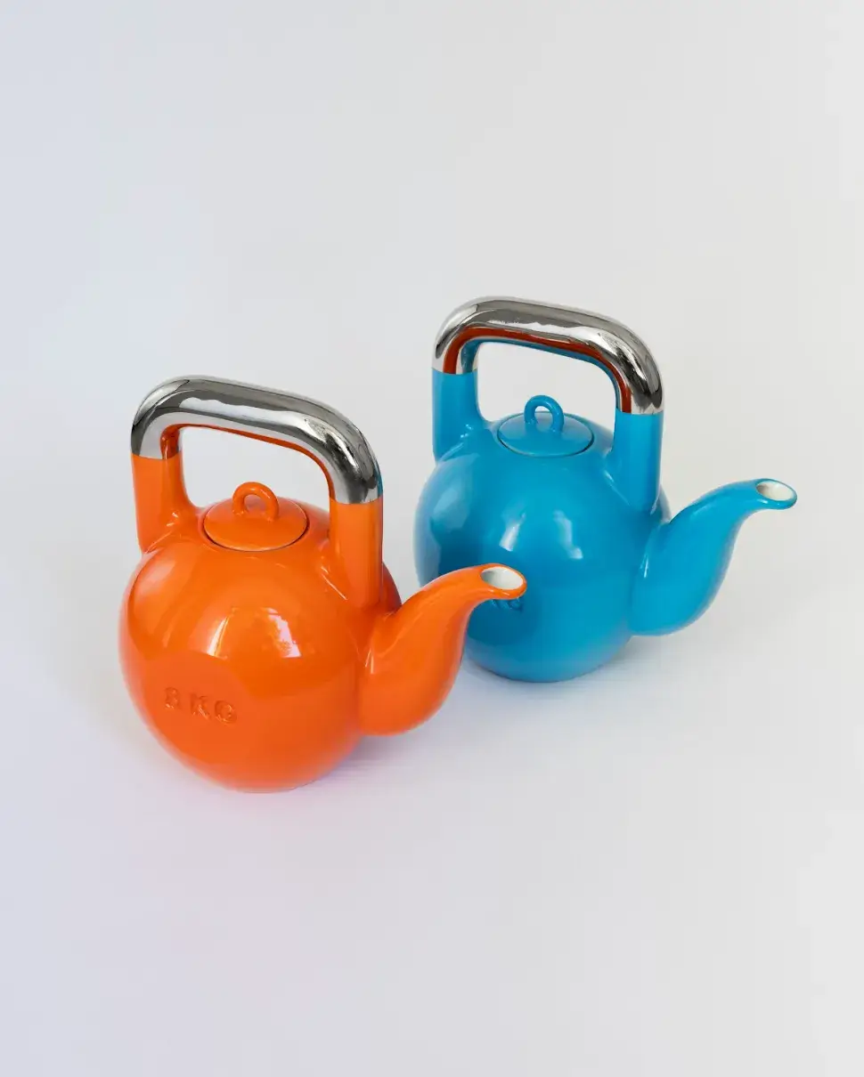 KPM BERLIN AND SUCUK UND BRATWURST DROP A KETTLEBELL TEAPOT image about a limited edition porcelain teapot shaped like a kettlebell, made in collaboration between KPM Berlin and Sucuk und Bratwurst, available from June 2026. (image 9 of 9)