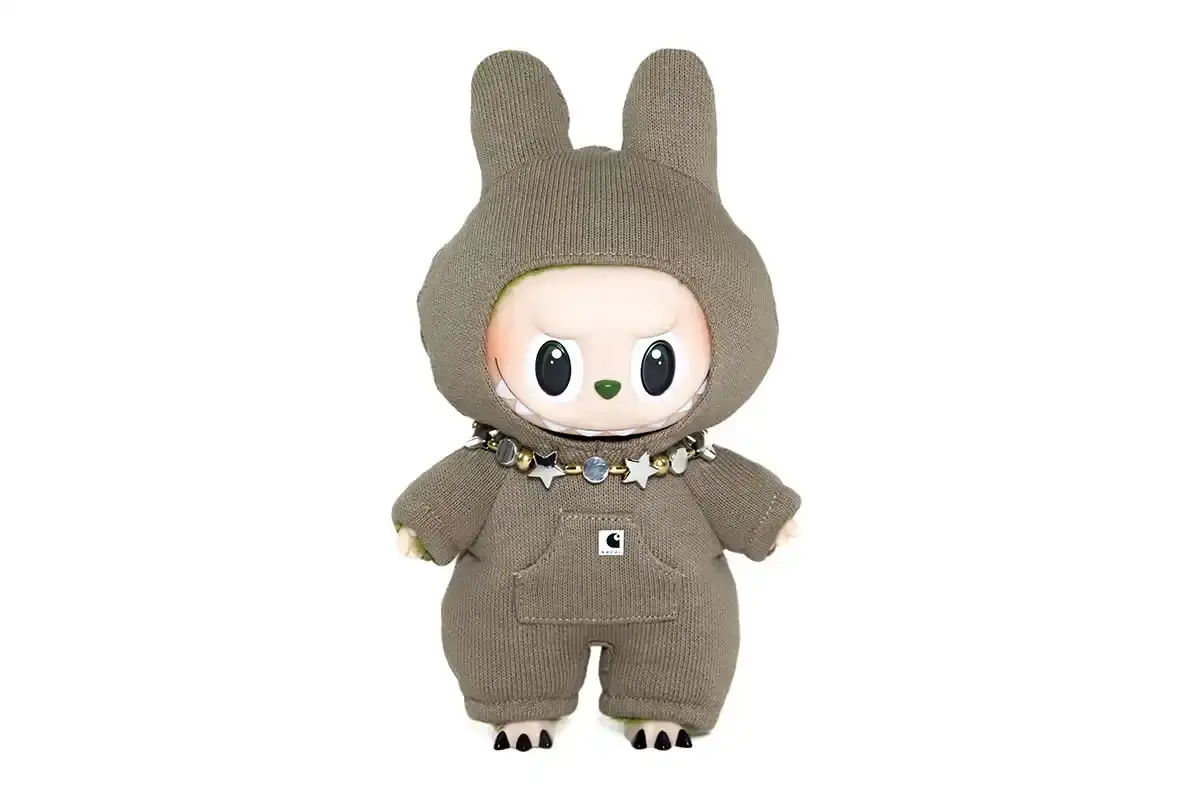 LABUBU COLLECTIBLES REACH NEW AUCTION HEIGHTS Article reports on a successful auction featuring 14 custom LABUBU collectibles designed through a collaboration between fashion brand sacai and K-pop group SEVENTEEN. The auction achieved complete sales totaling $337,500, with one collectible setting a new record at $31,250. All proceeds benefit UNESCO through the organization's partnerships with SEVENTEEN and Pharrell Williams as goodwill ambassadors. The text includes details about the collectibles' design, auction highlights, and market significance. (image 3 of 16)