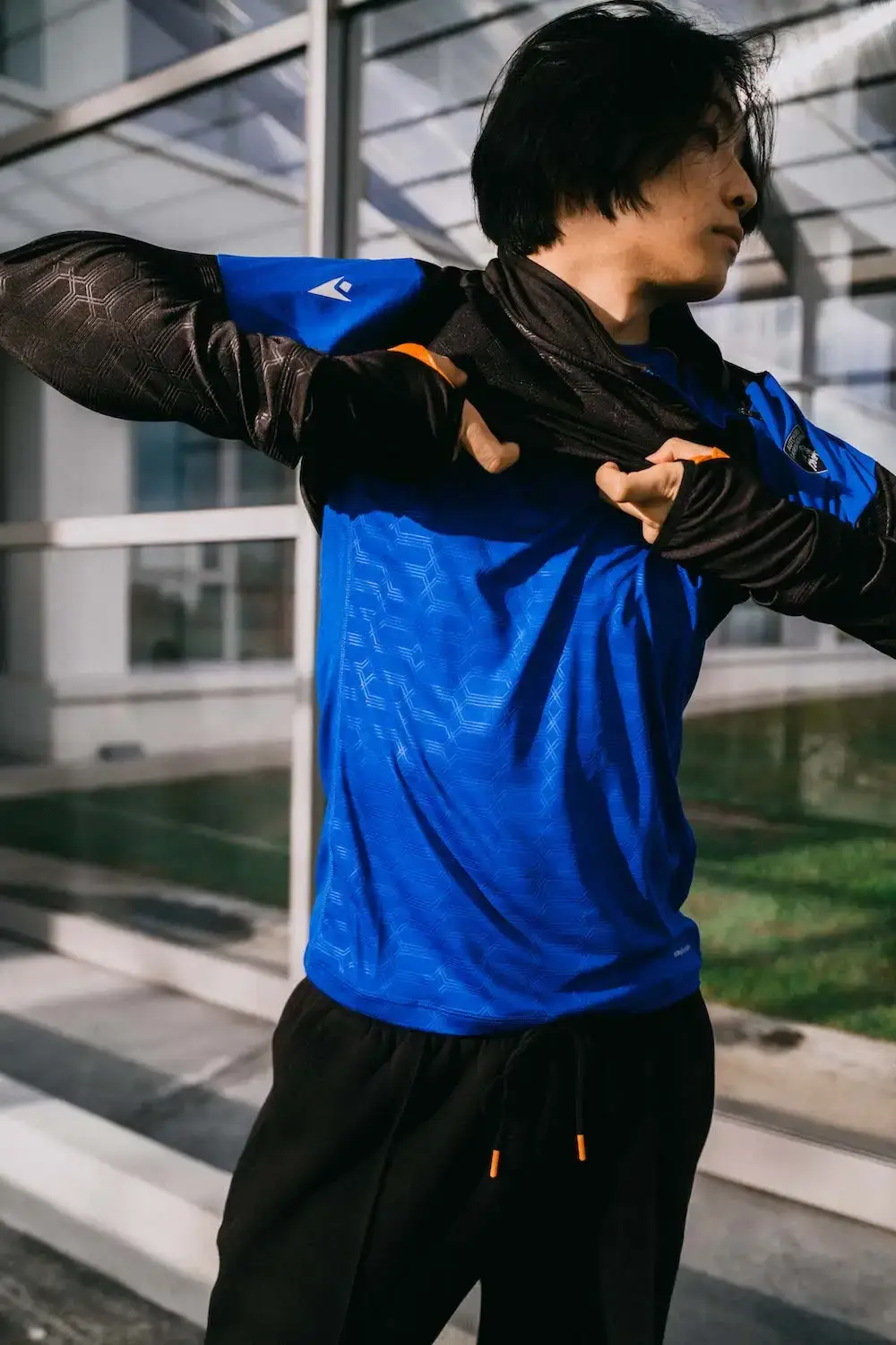 Lamborghini x Macron Lamborghini x Macron activewear collection featuring sports clothing in orange, blue, green, and purple, showcasing technical athletic wear inspired by luxury automotive design (image 2 of 5)