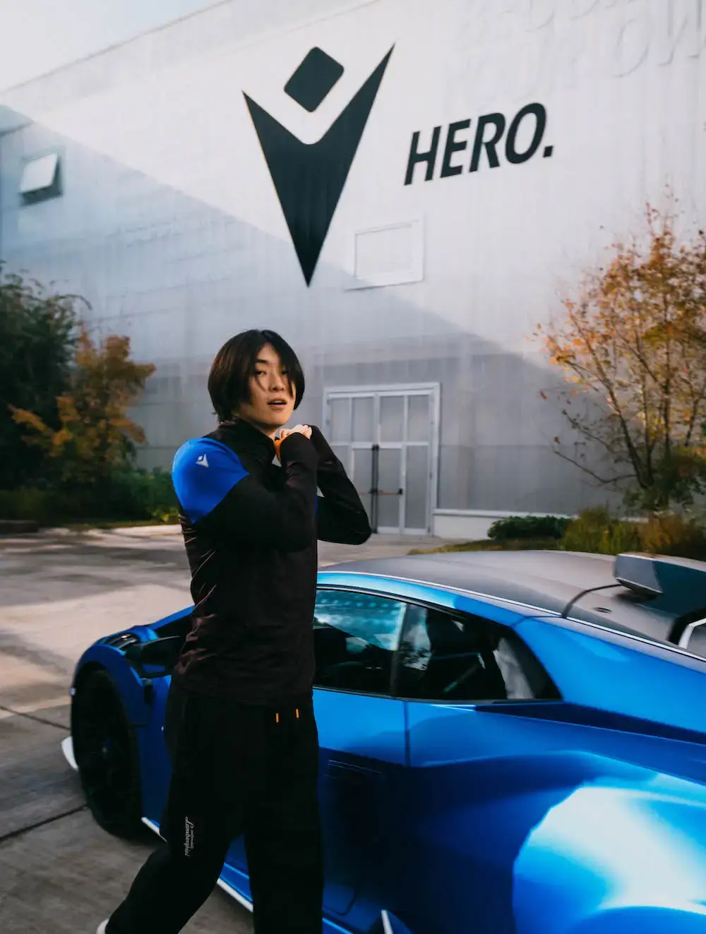 Lamborghini x Macron Lamborghini x Macron activewear collection featuring sports clothing in orange, blue, green, and purple, showcasing technical athletic wear inspired by luxury automotive design (image 3 of 5)