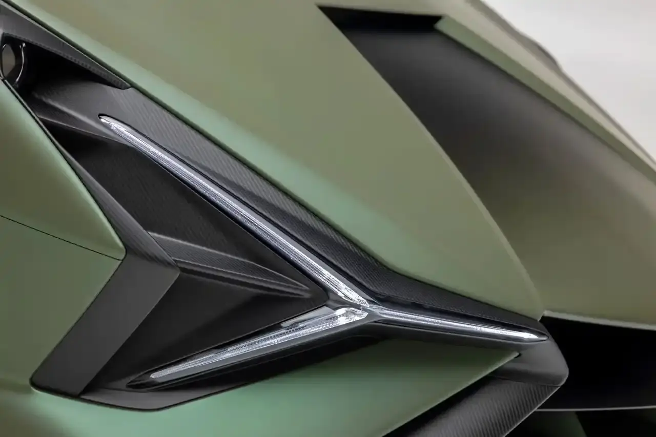 Bring A Trailer Verde Triton 2021 Lamborghini Sián FKP 37 hybrid supercar with gold wheels photographed in profile view showing its aerodynamic design. (image 9 of 9)