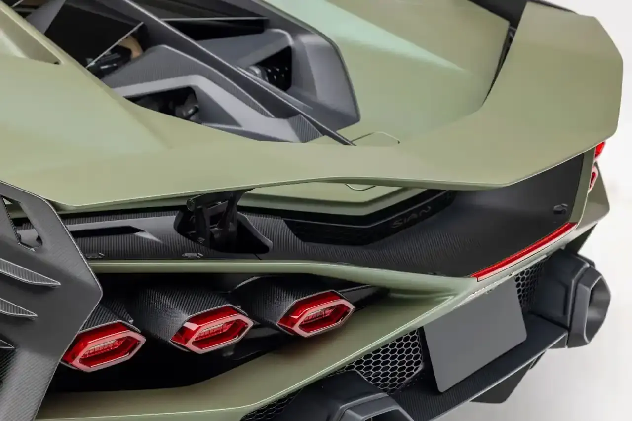 Bring A Trailer Verde Triton 2021 Lamborghini Sián FKP 37 hybrid supercar with gold wheels photographed in profile view showing its aerodynamic design. (image 8 of 9)
