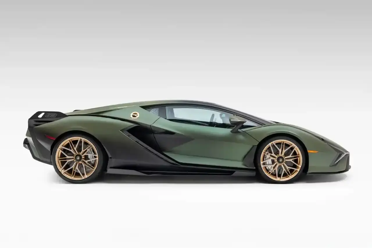Bring A Trailer Verde Triton 2021 Lamborghini Sián FKP 37 hybrid supercar with gold wheels photographed in profile view showing its aerodynamic design. (image 4 of 9)