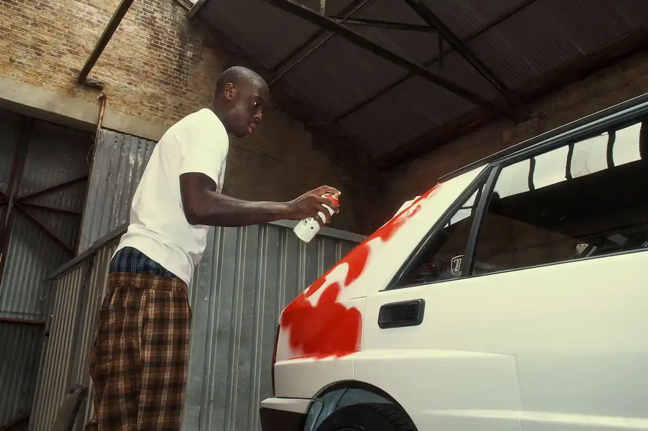 Spot A Lancia Delta Integrale rally car painted by artist Slawn, featuring bold artistic interpretations of the classic Martini racing livery with contemporary street art elements. (image 9 of 13)