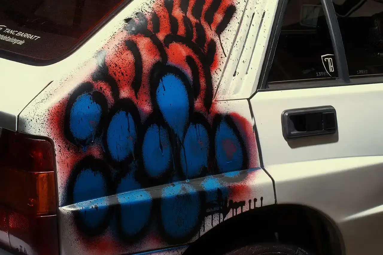 Spot A Lancia Delta Integrale rally car painted by artist Slawn, featuring bold artistic interpretations of the classic Martini racing livery with contemporary street art elements. (image 4 of 13)