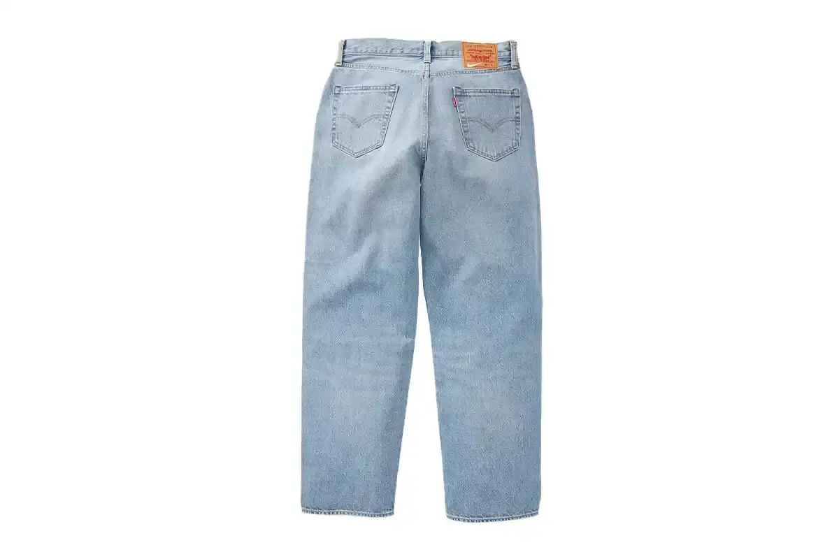 LEVI'S NIKE COLLECTION MERGES ATHLETIC AND DENIM STYLES image about fashion collaboration between Levi's and Nike, describing new clothing collection that combines denim craftsmanship with athletic design elements. Includes details about product features, release dates, and marketing campaign featuring athletes and cultural figures. (image 4 of 4)