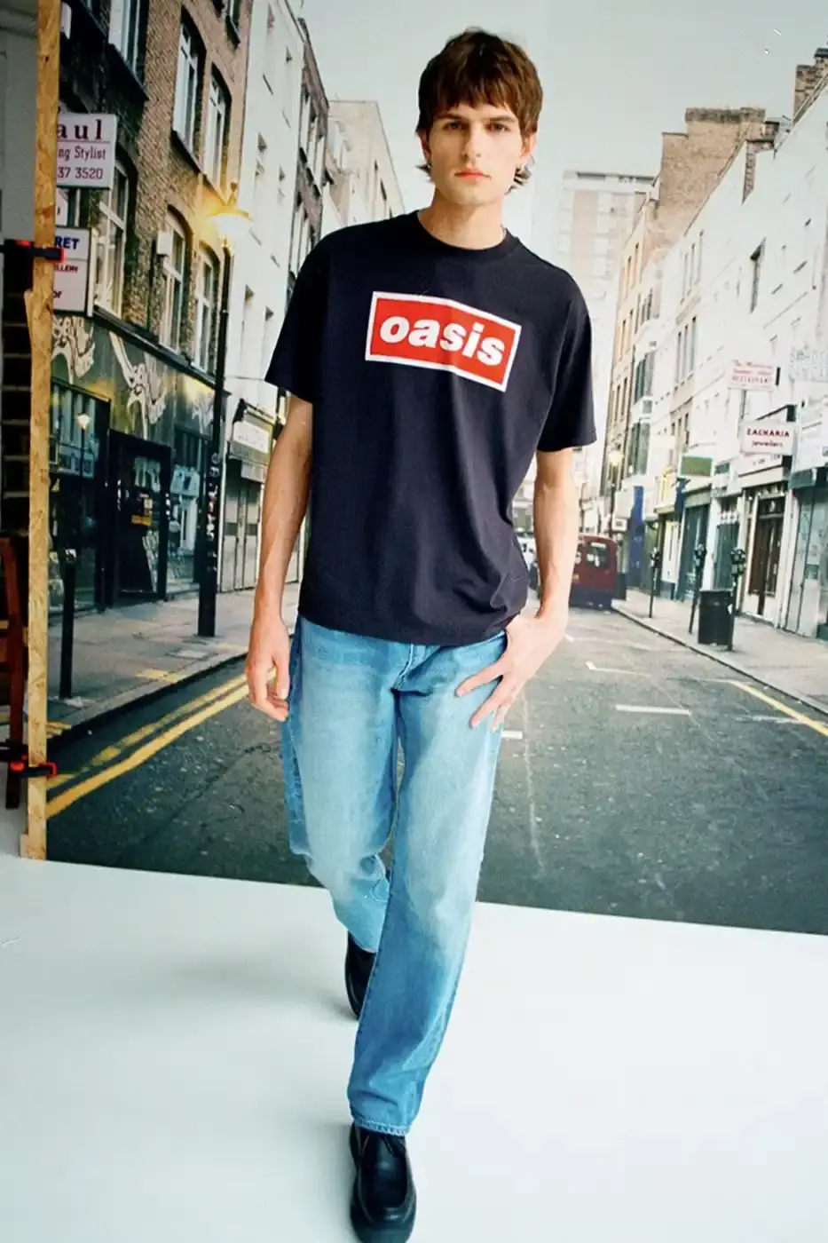 LEVI'S OASIS COLLECTION MARKS BAND'S RETURN image of Levi's new clothing collection inspired by British rock band Oasis, featuring T-shirts with vintage logos and denim pieces including Liam Gallagher's signature parka style. Collection currently available in Europe with worldwide release planned for 2025 (image 12 of 15)