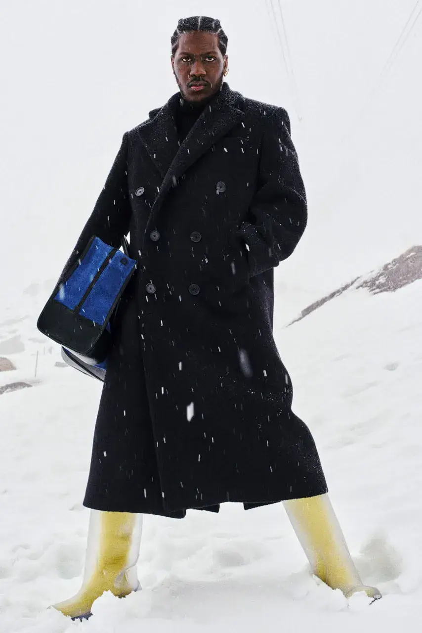 LIL YACHTY LEADS LOEWE FALL CAMPAIGN image detailing musician Lil Yachty and actress Julia Garner starring in a LOEWE fashion campaign filmed in the Alps. (image 2 of 11)