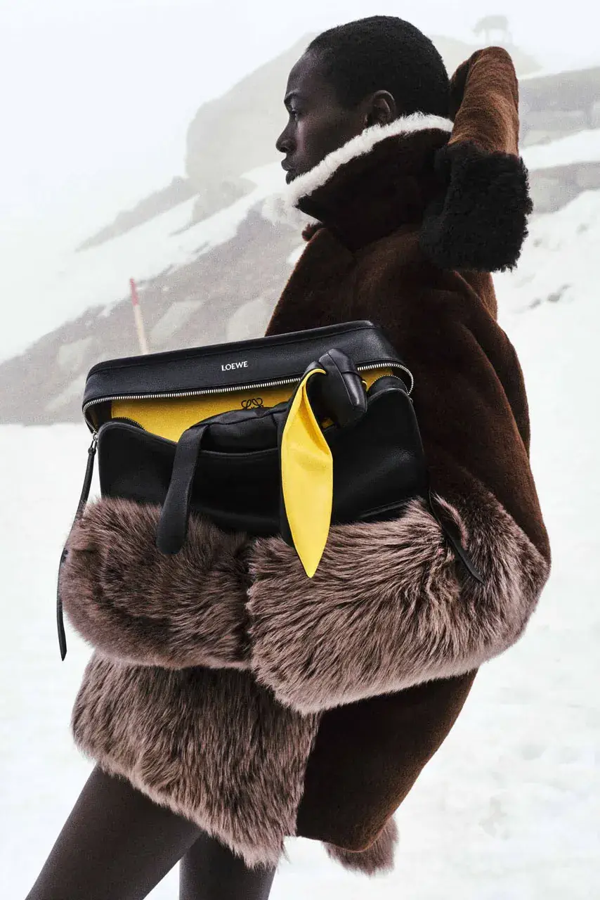 LIL YACHTY LEADS LOEWE FALL CAMPAIGN image detailing musician Lil Yachty and actress Julia Garner starring in a LOEWE fashion campaign filmed in the Alps. (image 6 of 11)