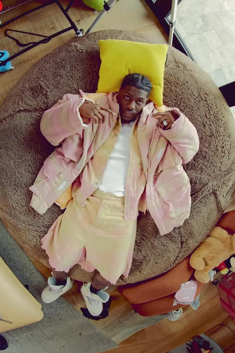 Lil Yachty, Camo!, and Draft Day of Concrete Boys modeling PDF by Domenico Formichetti's Fall/Winter 2024 collection 'The Dirt'. Yachty wears oversized pastel denim shorts and cardigan with moon shoes. Group shot through fish-eye lens capturing '90s street style aesthetic (image 2 of 3)