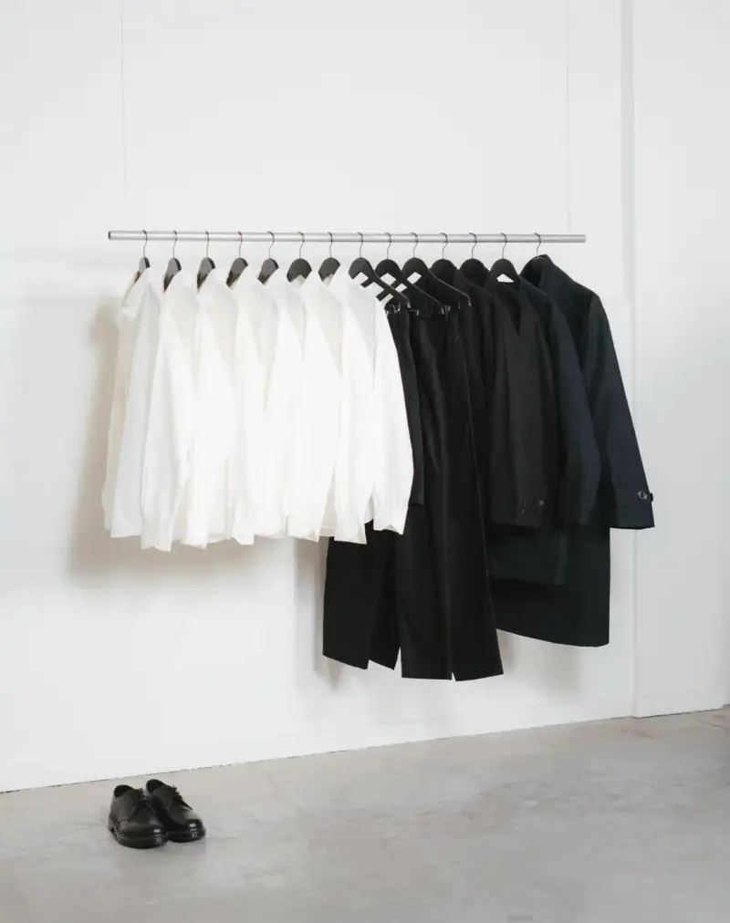 HOW SHAI DATAUKER REDEFINES CLOTHING, IDENTITY, AND DAILY LIFE Shai Datauker wearing his daily uniform-a bright red Adidas tracksuit and white t-shirt-sitting in a minimalist interior during an interview about fashion and identity. (image 9 of 9)