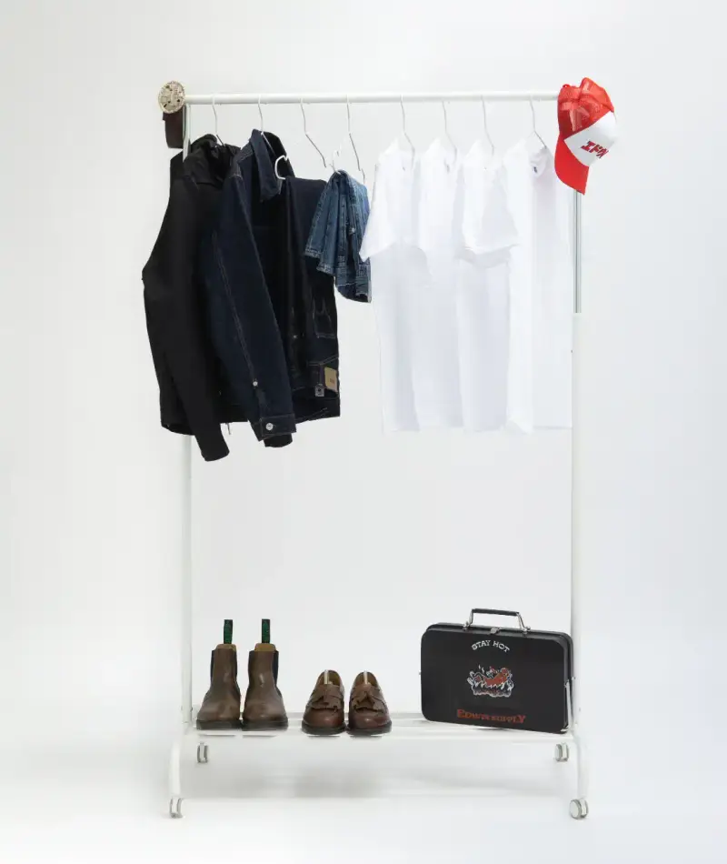 HOW SHAI DATAUKER REDEFINES CLOTHING, IDENTITY, AND DAILY LIFE Shai Datauker wearing his daily uniform-a bright red Adidas tracksuit and white t-shirt-sitting in a minimalist interior during an interview about fashion and identity. (image 7 of 7)