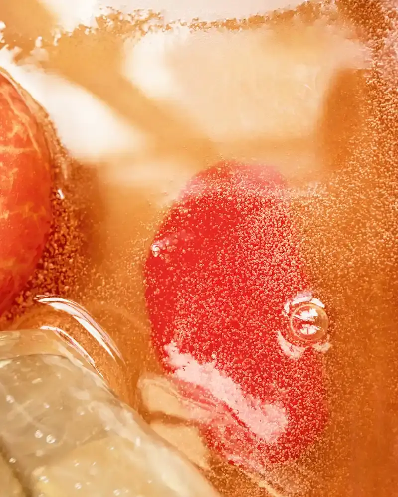 LOEWE PERFUMES EXPANDS CRAFTED COLLECTION Image series showing still-life perfume bottles with granite caps alongside raw botanical ingredients, pigment powders, and fresh citrus slices. (image 10 of 10)
