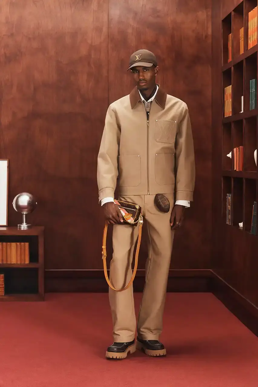 LOUIS VUITTON FALL 2026 MENSWEAR PREVIEW image about Louis Vuitton's upcoming Fall 2026 menswear collection designed by Pharrell Williams. The piece discusses the collection's American collegiate inspiration, key design elements including tartan patterns and heritage stripes, outerwear focus, and September release timeline. Contains detailed descriptions of clothing items, patterns, materials, and accessories without accompanying images.