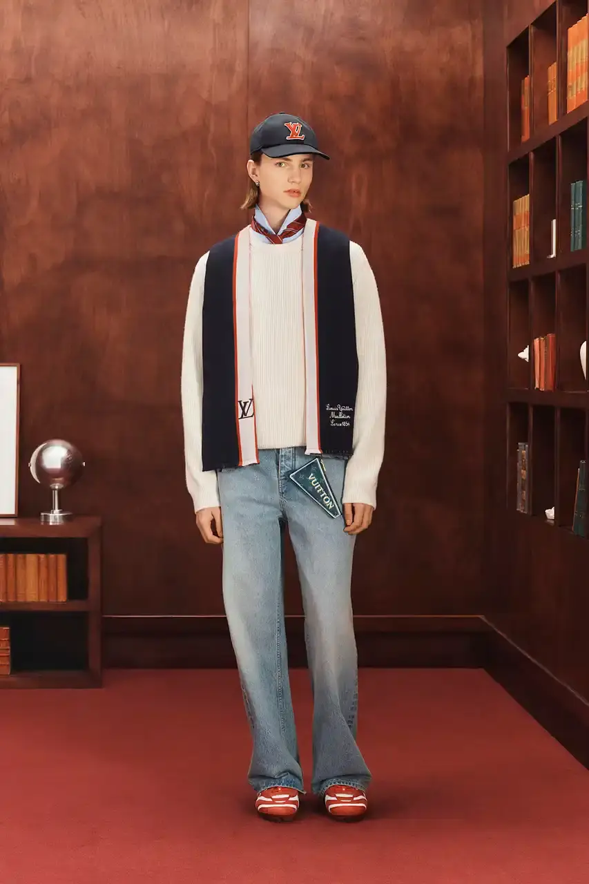 LOUIS VUITTON FALL 2026 MENSWEAR PREVIEW image about Louis Vuitton's upcoming Fall 2026 menswear collection designed by Pharrell Williams. The piece discusses the collection's American collegiate inspiration, key design elements including tartan patterns and heritage stripes, outerwear focus, and September release timeline. Contains detailed descriptions of clothing items, patterns, materials, and accessories without accompanying images. (image 10 of 29)