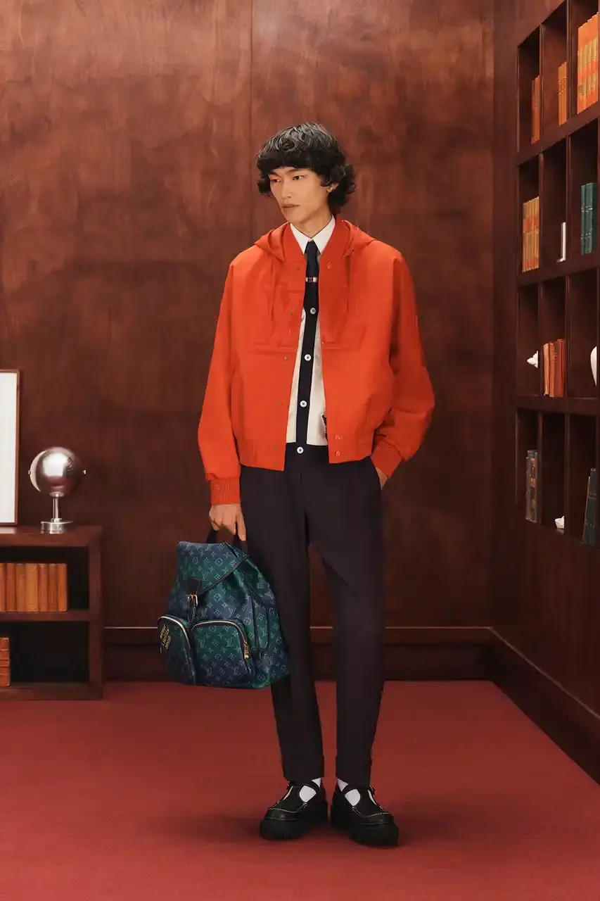 LOUIS VUITTON FALL 2026 MENSWEAR PREVIEW image about Louis Vuitton's upcoming Fall 2026 menswear collection designed by Pharrell Williams. The piece discusses the collection's American collegiate inspiration, key design elements including tartan patterns and heritage stripes, outerwear focus, and September release timeline. Contains detailed descriptions of clothing items, patterns, materials, and accessories without accompanying images. (image 11 of 29)