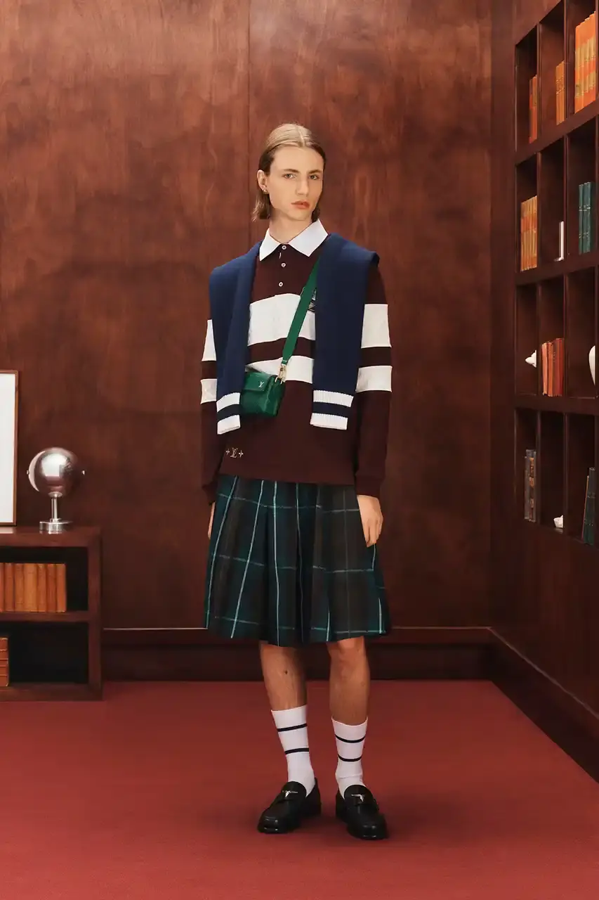 LOUIS VUITTON FALL 2026 MENSWEAR PREVIEW image about Louis Vuitton's upcoming Fall 2026 menswear collection designed by Pharrell Williams. The piece discusses the collection's American collegiate inspiration, key design elements including tartan patterns and heritage stripes, outerwear focus, and September release timeline. Contains detailed descriptions of clothing items, patterns, materials, and accessories without accompanying images. (image 7 of 29)