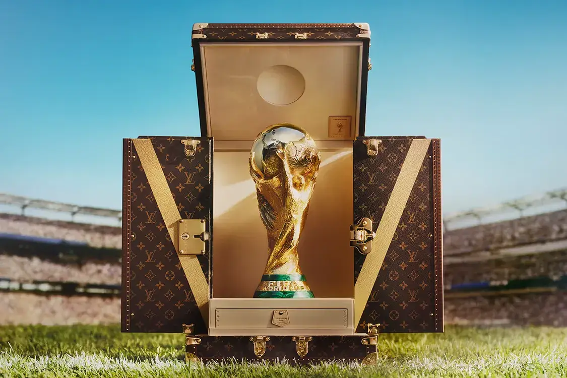 LOUIS VUITTON FIFA WORLD CUP 2026 TROPHY TRUNK An image of the custom Louis Vuitton Trophy Trunk for the 2026 FIFA World Cup, featuring the classic Monogram canvas and brass hardware.