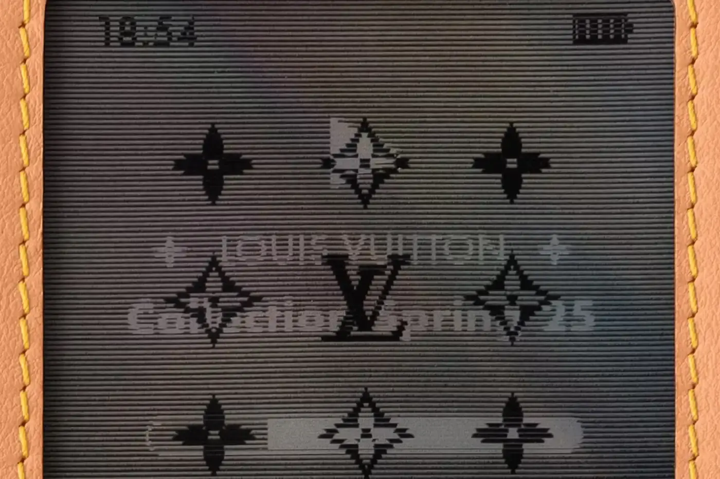 Louis Vuitton Louis Vuitton Spring 2025 accessories collection featuring music technology-inspired luxury items. The image shows an iPod-shaped leather crossbody bag with a display screen showing 'Louis Vuitton Collection Spring 2025' and an LV monogram replacing the scroll wheel. Also visible are a cassette player-styled wallet with embossed control buttons and a cassette tape card holder with 'Side A' and 'Side B' graphics. Gold headphone-shaped zipper pulls complete the nostalgic design. (image 13 of 17)
