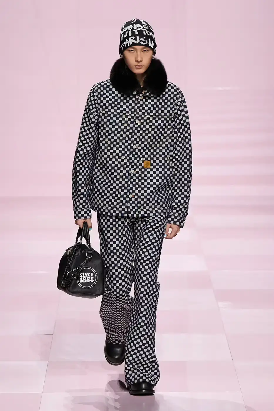 Louis Vuitton Louis Vuitton's Fall/Winter 2025 menswear collection, detailing the creative collaboration between Pharrell Williams and NIGO, featuring streetwear elements, Japanese craftsmanship, and French luxury design, with references to historical brand elements and new patterns. (image 5 of 23)