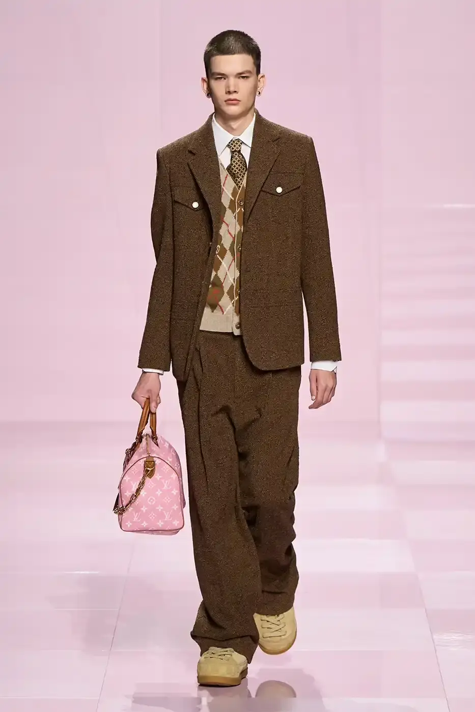 Louis Vuitton Louis Vuitton's Fall/Winter 2025 menswear collection, detailing the creative collaboration between Pharrell Williams and NIGO, featuring streetwear elements, Japanese craftsmanship, and French luxury design, with references to historical brand elements and new patterns.